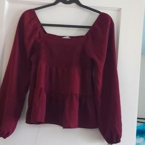 A reddish, pinkish top, long sleeved, paper crane(brand)
